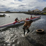 
              Crew members prepare for a training session for the Hoki Mai challenge, a canoe voyage — covering almost 500 kilometers, or about 300 miles across a stretch of the Pacific Ocean, in Rapa Nui, a territory that is part of Chile and is better known as Easter Island, Thursday, Nov. 24, 2022. Hoki Mai pursues three goals. The first is to honor canoeing in Polynesia, which has been practiced for centuries. The second is related to the environment. The third purpose relates to gender equality. (AP Photo/Esteban Felix)
            