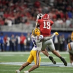 Georgia linebacker Darris Smith (19) completes a catch against LSU safety Greg Brooks Jr. (3) in the first half of the Southeastern Conference championship NCAA college football game, Saturday, Dec. 3, 2022, in Atlanta. (AP Photo/Brynn Anderson)