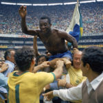 
              FILE - Brazil's Pele is hoisted on the shoulders of his teammates after Brazil won the World Cup final against Italy, 4-1, in Mexico City's Estadio Azteca, June 21, 1970.  Pelé, the Brazilian king of soccer who won a record three World Cups and became one of the most commanding sports figures of the last century, died in sao Paulo on Thursday, Dec. 29, 2022. He was 82. (AP Photo, File)
            