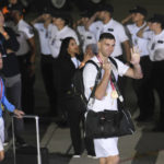 
              Goalkeeper Emiliano Martinez waves upon the arrival of players from the Argentine soccer team in Buenos Aires, Argentina, Tuesday, Dec. 20, 2022. (AP Photo/Gustavo Garello)
            
