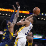 
              Golden State Warriors guard Jordan Poole (3) shoots over Indiana Pacers forward Oshae Brisket (12) during the first half of an NBA basketball game in Indianapolis, Wednesday, Dec. 14, 2022. (AP Photo/Michael Conroy)
            