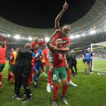 Morocco's players celebrate after winning the World Cup quarterfinal soccer match between Morocco and Portugal, at Al Thumama Stadium in Doha, Qatar, Saturday, Dec. 10, 2022. (AP Photo/Martin Meissner)