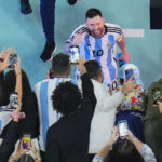 
              Argentina's Lionel Messi greets cheering fans after his team's 3-0 win in the World Cup semifinal soccer match between Argentina and Croatia at the Lusail Stadium in Lusail, Qatar, Wednesday, Dec. 14, 2022. (AP Photo/Hassan Ammar)
            