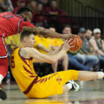
              St. John's guard Posh Alexander (0) and Iowa State forward Aljaz Kunc (5) battle for the ball at mid court during the first half of an NCAA college basketball game, Sunday, Dec. 4, 2022, in Ames, Iowa. (AP Photo/ Matthew Putney)
            