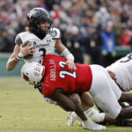 Cincinnati quarterback Evan Prater is sacked by Louisville's Yasir Abdullah during the second quarter of the Fenway Bowl NCAA college football game at Fenway Park Saturday, Dec. 17, 2022, in Boston. (AP Photo/Winslow Townson)