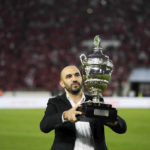 
              Morocco's national team head coach Walid Regragui presents the CAF Super Cup trophy before the game between Moroccan teams RS Berkane and Wydad AC, in Rabat, Morocco, Saturday Sept. 10, 2022. RS Berkane were crowned CAF Super Cup champions for the first time after defeating Wydad Casablanca 2-0 on Saturday evening. (AP Photo/Mosa'ab Elshamy)
            