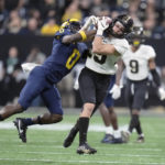 Purdue Andrew Sowinski catches a 24-yard pass pass as Michigan defensive back Mike Sainristil defends during the second half of the Big Ten championship NCAA college football game, Saturday, Dec. 3, 2022, in Indianapolis. (AP Photo/Michael Conroy)