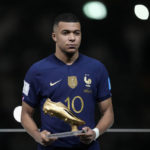 
              France's Kylian Mbappe holds the Golden Boot award for top goalscorer of the tournament after the World Cup final soccer match between Argentina and France at the Lusail Stadium in Lusail, Qatar, Sunday, Dec. 18, 2022. Argentina won 4-2 in a penalty shootout after the match ended tied 3-3. (AP Photo/Martin Meissner)
            