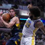 
              Indiana Pacers guard T.J. McConnell (9) grabs a rebound in front of Golden State Warriors forward Anthony Lamb (40) during the first half of an NBA basketball game in Indianapolis, Wednesday, Dec. 14, 2022. (AP Photo/Michael Conroy)
            