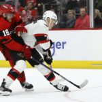 Ottawa Senators left wing Brady Tkachuk (7) blocks Detroit Red Wings center Andrew Copp (18) from the puck during the second period of an NHL hockey game Saturday, Dec. 31, 2022, in Detroit. (AP Photo/Duane Burleson)