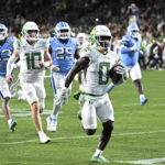 Oregon running back Bucky Irving (0) runs for a touchdown against North Carolina during the first half of the Holiday Bowl NCAA college football game Wednesday, Dec. 28, 2022, in San Diego. (AP Photo/Denis Poroy)