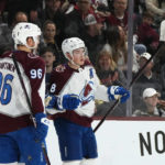 Colorado Avalanche defenseman Cale Makar (8) celebrates his goal against the Arizona Coyotes with teammates, including Avalanche right wing Mikko Rantanen (96), during the second period of an NHL hockey game in Tempe, Ariz., Tuesday, Dec. 27, 2022. (AP Photo/Ross D. Franklin)