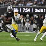 Las Vegas Raiders running back Josh Jacobs (28) carries for a touchdown during the first half of an NFL football game against the Los Angeles Chargers, Sunday, Dec. 4, 2022, in Las Vegas. (AP Photo/David Becker)