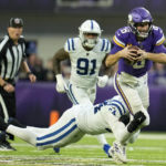 Minnesota Vikings quarterback Kirk Cousins (8) is sacked by Indianapolis Colts defensive end Dayo Odeyingbo (54) during the second half of an NFL football game, Saturday, Dec. 17, 2022, in Minneapolis. (AP Photo/Abbie Parr)