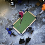
              People play pool in Harare, capital of Zimbabwe, Thursday, Nov. 24, 2022. Previously a minority and elite sport in Zimbabwe, the game has increased in popularity over the years, first as a pastime and now as a survival mode for many in a country where employment is hard to come by. (AP Photo/Tsvangirayi Mukwazhi)
            