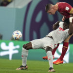 
              Serbia's Nikola Milenkovic, right, and Switzerland's Breel Embolo, challenge for the ball during the World Cup group G soccer match between Serbia and Switzerland, in Doha, Qatar, Qatar, Friday Dec. 2, 2022. (AP Photo/Ricardo Mazalan)
            