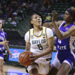 Baylor guard Darianna Littlepage-Buggs (5) drives to the basket past Tennessee State forward Kianni Westbrook (4) in the second half of an NCAA college basketball game, Thursday, Dec. 15, 2022, in Waco, Texas. (Rod Aydelotte/Waco Tribune-Herald, via AP)