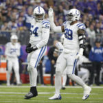 Indianapolis Colts defensive end Dayo Odeyingbo (54) celebrates with teammate defensive tackle DeForest Buckner (99) after a defensive stop during the first half of an NFL football game against the Minnesota Vikings, Saturday, Dec. 17, 2022, in Minneapolis. (AP Photo/Andy Clayton-King)