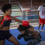 
              Boxer Giselle Bello Garcia, left, throws a punch at Ydamelys Moreno during a training session in Havana, Cuba, Monday, Dec. 5, 2022. Cuban officials announced on Monday that women boxers would be able to compete for the first time ever. (AP Photo/Ramon Espinosa)
            