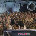 
              In this handout photo from the U.S. Air Force, American service members participate in a live broadcast with the hosts of Fox NFL Sunday during their Salute to Veterans broadcast, Nov. 13, 2022 at Al-Udeid Air Base in Qatar. As over a million World Cup fans fill stadiums with cheers and carry heady optimism through the streets of Doha, some 8,000 American troops are running air wars in Afghanistan, Iraq, Syria and other hotspots in the Middle East mere miles away. (U.S. Air Force/Airman 1st Class Andrew Britten, via AP)
            