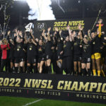 
              FILE - Portland Thorns FC celebrates with the trophy after the won the NWSL championship soccer match against the Kansas City Current, Saturday, Oct. 29, 2022, in Washington. The owner of the Portland Thorns announced Thursday, Dec. 1, he is putting the club up for sale, the latest fallout from an investigation into misconduct in the National Women’s Soccer League. (AP Photo/Nick Wass, File)
            