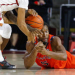 
              Auburn forward Chris Moore, right, dives into the ball against Southern California guard Boogi Ellis during the first half of an NCAA college basketball game Sunday, Dec. 18, 2022, in Los Angeles. (AP Photo/Ringo H.W. Chiu)
            