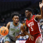 
              Baylor guard LJ Cryer (4) battles Washington State guard TJ Bamba (5) for space during the first half of an NCAA college basketball game on Sunday, Dec. 18, 2022, in Dallas. (AP Photo/Brandon Wade)
            