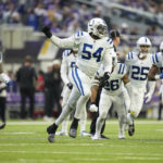 Indianapolis Colts defensive end Dayo Odeyingbo (54) celebrates with teammates after a fourth down stop during the first half of an NFL football game against the Minnesota Vikings, Saturday, Dec. 17, 2022, in Minneapolis. (AP Photo/Abbie Parr)