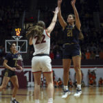
              Notre Dame's Maddy Westbeld (21) shoots over Virginia Tech's Cayla King (22) in the first half of an NCAA college basketball game in Blacksburg, Va., Sunday, Dec. 18, 2022. (Matt Gentry/The Roanoke Times via AP)
            