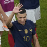 France's Kylian Mbappe waves his hand at the end of the World Cup round of 16 soccer match between France and Poland, at the Al Thumama Stadium in Doha, Qatar, Sunday, Dec. 4, 2022. (AP Photo/Christophe Ena)
