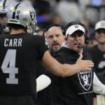 
              Las Vegas Raiders quarterback Derek Carr is congratulated by offensive coordinator Mike Lombardi after a touchdown pass during the first half of an NFL football game between the New England Patriots and Las Vegas Raiders, Sunday, Dec. 18, 2022, in Las Vegas. (AP Photo/John Locher)
            