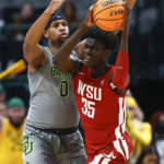 Washington State forward Mouhamed Gueye (35) battles Baylor forward Flo Thamba (0) for space during the first half of an NCAA college basketball game on Sunday, Dec. 18, 2022, in Dallas. (AP Photo/Brandon Wade)