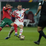 
              Morocco's Hakim Ziyech, left, and Croatia's Mateo Kovacic fight for the ball during the World Cup third-place playoff soccer match between Croatia and Morocco at Khalifa International Stadium in Doha, Qatar, Saturday, Dec. 17, 2022. (AP Photo/Francisco Seco)
            
