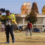 
              Pavan Kumar Machiraju walks off the field after batting during a cricket match between the Dallas Cricket Connections and the Kingswood Cricket Club, as the Karya Siddhi Hanuman Temple is seen in the background, in Frisco, Texas, Saturday, Oct. 22, 2022. (AP Photo/Andy Jacobsohn)
            