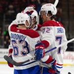 Montreal Canadiens' Evgenii Dadonov (63) congratulates Arber Xhekaj's (72) after he scored their second goal against the Arizona Coyotes in the second period during an NHL hockey game, Monday, Dec. 19, 2022, in Tempe, Ariz. (AP Photo/Darryl Webb)