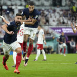 France's Olivier Giroud, left, celebrates with France's Kylian Mbappe, after scoring the opening goal during the World Cup round of 16 soccer match between France and Poland, at the Al Thumama Stadium in Doha, Qatar, Sunday, Dec. 4, 2022. (AP Photo/Ebrahim Noroozi)