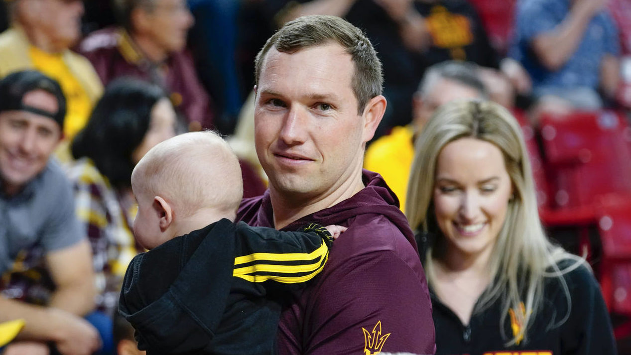 Arizona State's new football head coach Kenny Dillingham his son and wife Briana, right, attend the...