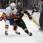 Arizona Coyotes center Nick Bjugstad shields New York Islanders defenseman Noah Dobson (8) from the puck in the first period during an NHL hockey game, Friday, Dec. 16, 2022, in Tempe, Ariz. (AP Photo/Rick Scuteri)