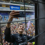 
              Mercedes driver George Russell, of Britain, takes a selfie with fans after winning the Brazilian Formula One Grand Prix, at the Interlagos race track in Sao Paulo, Brazil, on Nov. 13, 2022. (AP Photo/Marcelo Chello)
            