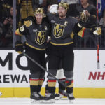 Vegas Golden Knights' right wing Mark Stone, right, celebrates his goal against the Arizona Coyotes with Reilly Smith (19) during the third period of an NHL hockey game Wednesday, Dec. 21, 2022, in Las Vegas. (AP Photo/Chase Stevens)