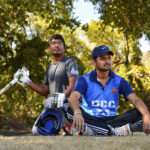 
              Suresh Bukkara Nagaraju, left, and Satay Das watch play from the sideline during a cricket match between the Dallas Cricket Connections and the Kingswood Cricket Club on a field adjacent to Roach Middle School in Frisco, Texas, Saturday, Oct. 22, 2022. The teams play in the City of Frisco Cricket league. (AP Photo/Andy Jacobsohn)
            