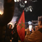 Morocco's fans celebrate after their team won the match against Spain at the World Cup soccer tournament in Qatar, in Turin, Italy, Tuesday, Dec. 6, 2022. (Marco Alpozzi/LaPresse via AP)
