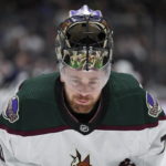 Arizona Coyotes goalie Karel Vejmelka skates during a stoppage in play during the third period of the team's NHL hockey game against the Vancouver Canucks on Saturday, Dec. 3, 2022, in Vancouver, British Columbia. (Darryl Dyck/The Canadian Press via AP)