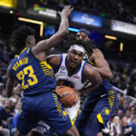 
              Golden State Warriors center Kevon Looney (5) tries to get around dIndiana Pacers forward Aaron Nesmith (23) during the first half of an NBA basketball game in Indianapolis, Wednesday, Dec. 14, 2022. (AP Photo/Michael Conroy)
            