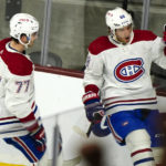Montreal Canadiens' Kirby Dach (77) watches teammate Mike Hoffman (68) celebrate his winning goal in overtime during an NHL hockey game against the Arizona Coyotes, Monday, Dec. 19, 2022, in Tempe, Ariz. Montreal won 3-2 over Arizona. (AP Photo/Darryl Webb)