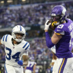 Minnesota Vikings wide receiver Adam Thielen (19) catches a 1-yard touchdown pass ahead of Indianapolis Colts cornerback Isaiah Rodgers (34) during the second half of an NFL football game, Saturday, Dec. 17, 2022, in Minneapolis. (AP Photo/Abbie Parr)