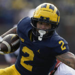
              FILE - Michigan running back Blake Corum (2) runs the ball against Illinois in the first half of an NCAA college football game in Ann Arbor, Mich., Saturday, Nov. 19, 2022. Corum was selected to The Associated Press All-America team released Monday, Dec. 12, 2022.(AP Photo/Paul Sancya, File)
            