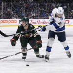 Winnipeg Jets' David Gustafsson takes a shot past Minnesota Wild's Calen Addison during the second period of an NHL hockey game in Winnipeg, Manitoba, on Tuesday Dec. 27, 2022. (Fred Greenslade/The Canadian Press via AP)