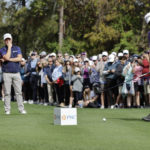 
              Tiger Woods, left, and Justin Thomas, center, watch Mike Thomas, right, tee off the first hole during the first round of the PNC Championship golf tournament Saturday, Dec. 17, 2022, in Orlando, Fla. (AP Photo/Kevin Kolczynski)
            