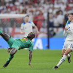 
              Senegal's Youssouf Sabaly, left, challenges with England's Phil Foden during the World Cup round of 16 soccer match between England and Senegal, at the Al Bayt Stadium in Al Khor, Qatar, Sunday, Dec. 4, 2022. (AP Photo/Hassan Ammar)
            